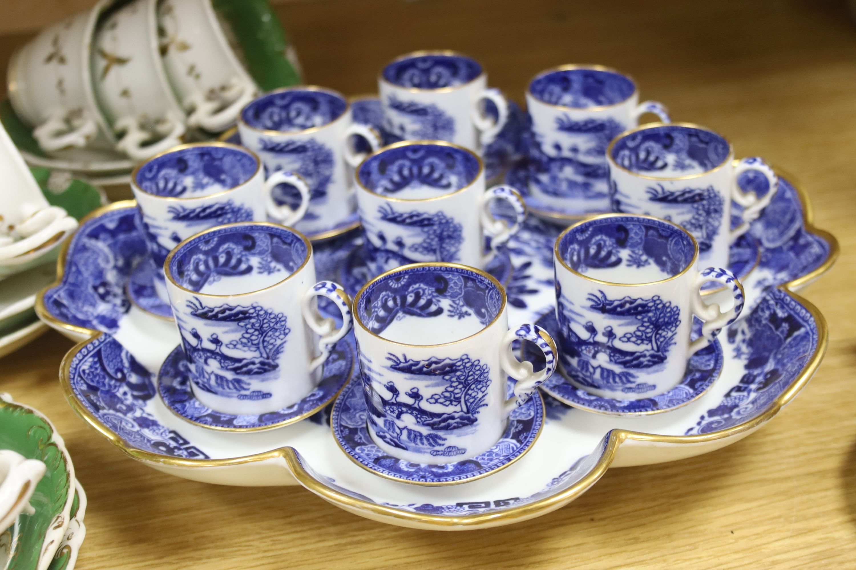 A Copeland blue and white nine cup and saucer cabaret set on stand and a 19th century Rockingham style green and gilt decorated tea ser